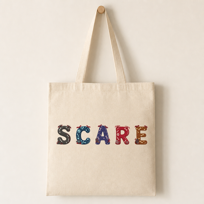 Plain canvas tote bag printed with a row of Midnight Spooks characters across the front showing the gothic decorations and accent highlights.