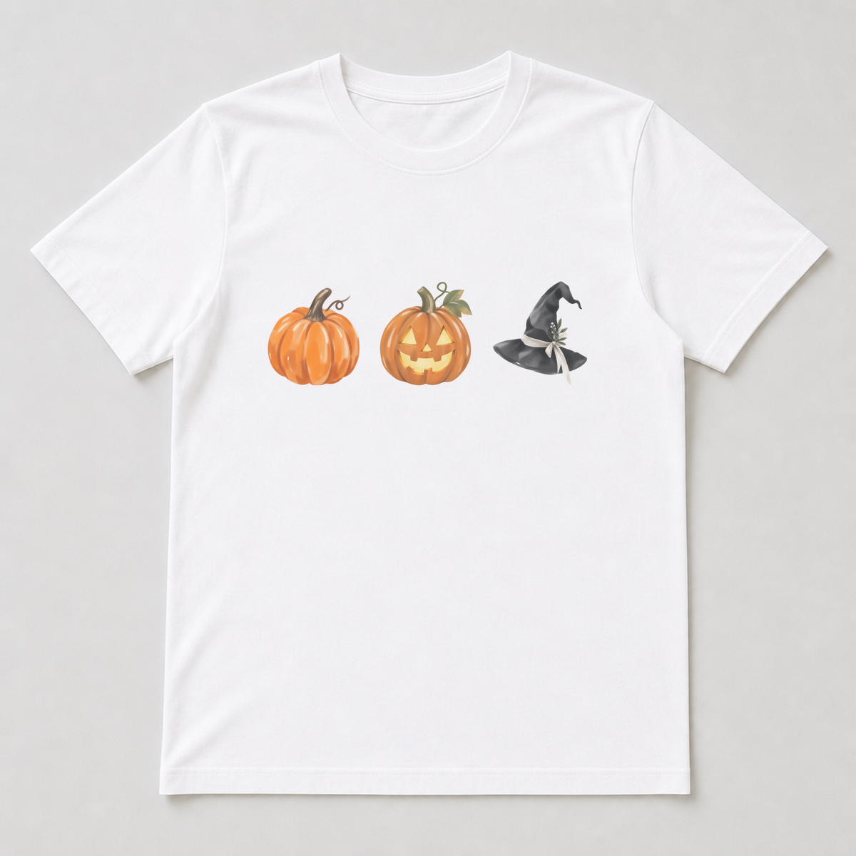 White t-shirt printed with a horizontal row of the Halloween characters, featuring carved pumpkins, witch hats and cobweb details with {accent} accents.